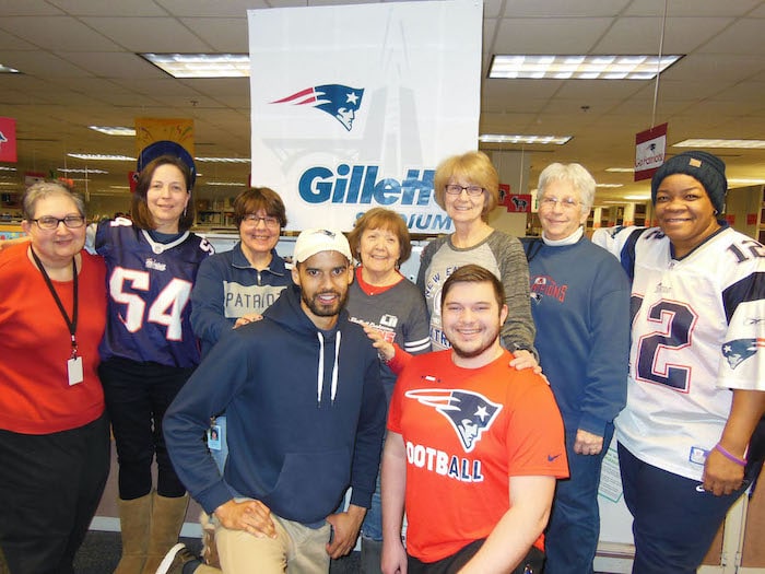 Group photo of Customer Service staff members wearing New England Patriots attire
