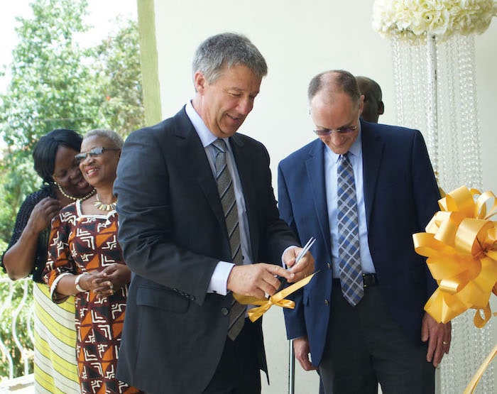 Our CEO assisting in a ribbon cutting ceremony in Uganda