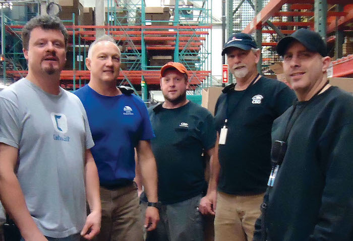 Group photo of maintenance staff in the warehouse