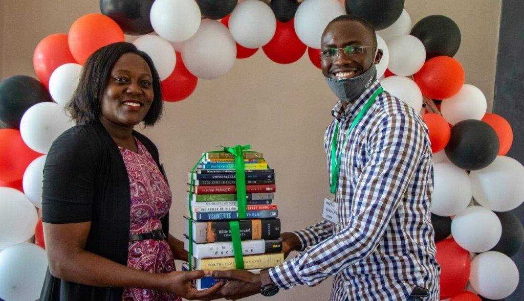 Bible college students in Uganda receiving personal libraries upon graduation